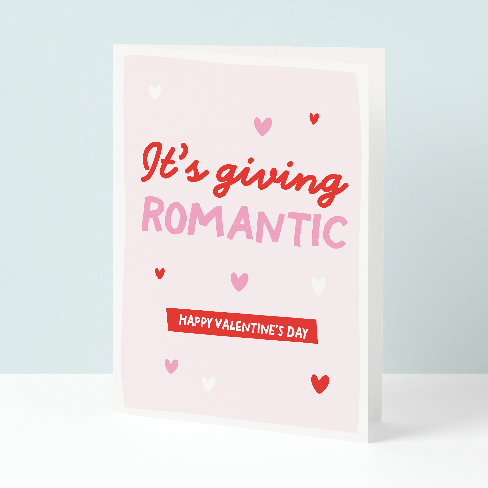 Valentine's Day card with red and pink text on a light blue background
